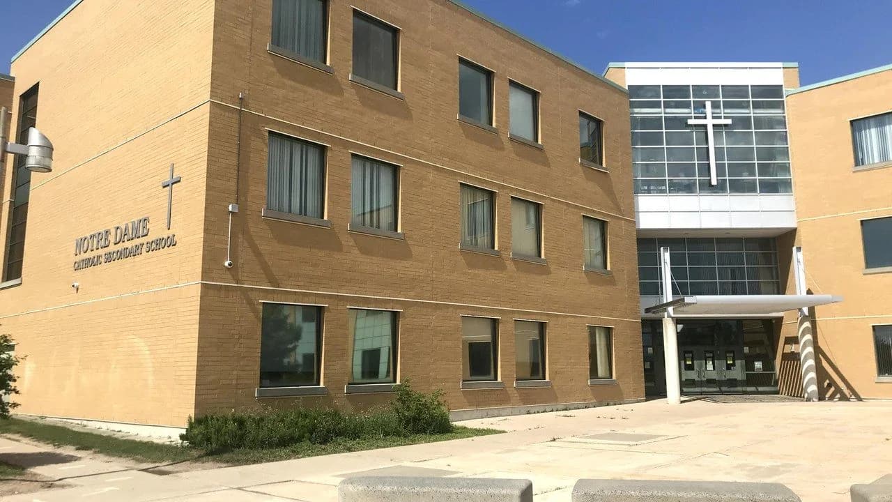 Front entrance of Notre Dame Catholic Secondary School, a Durham Catholic District School Board school in Ajax, Ontario; no people visible.