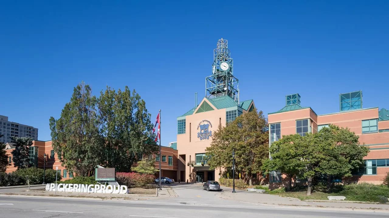 Pickering City Hall clock tower viewed from Glenanna Road on a clear day; no people visible.