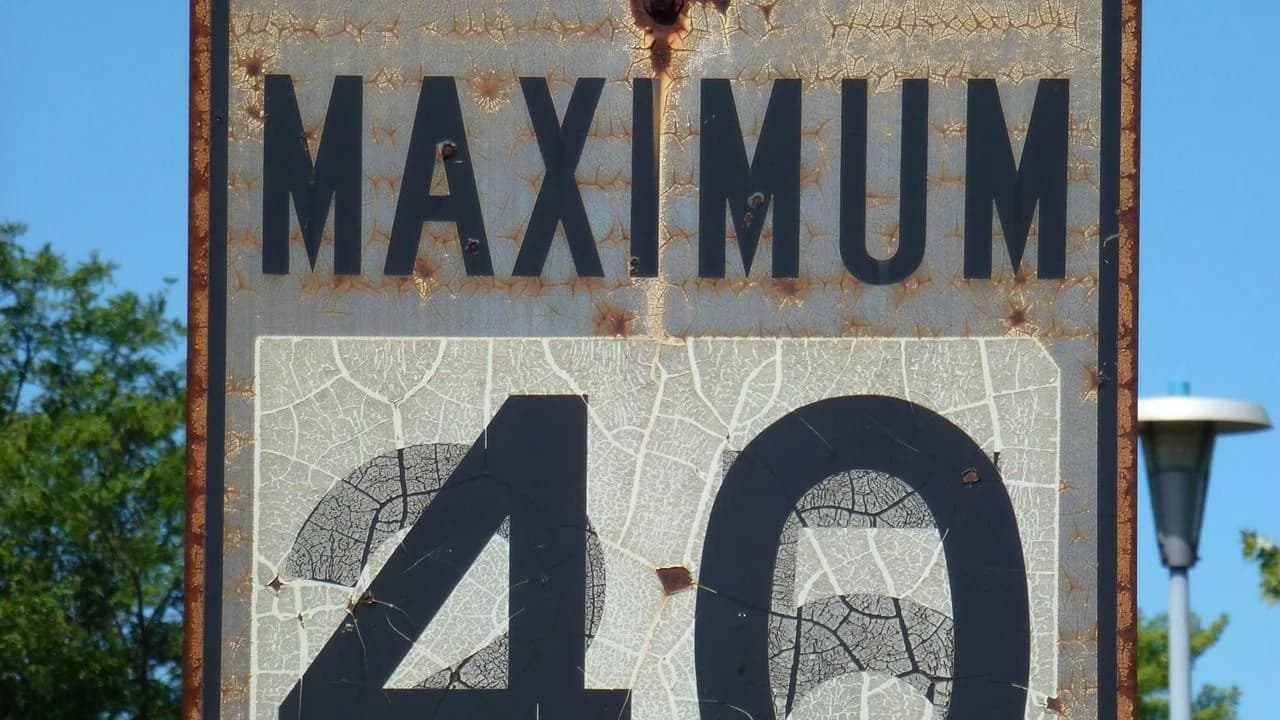 Close-up of a weathered Ontario 'Maximum 40' speed limit sign; no people visible.